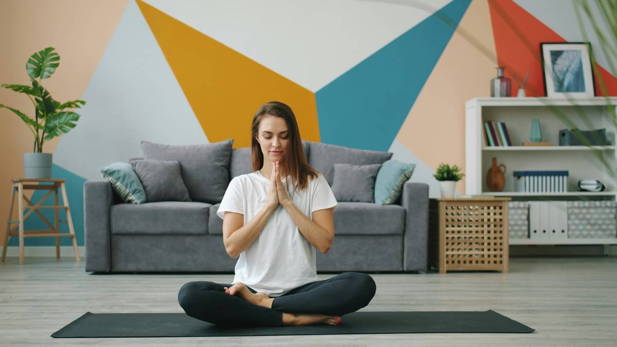 Woman meditating peacefully at sunrise, illustrating the path to inner peace